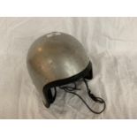 A VINTAGE SILVER COLOURED CRASH HAT