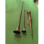 TWO COPPER HUNTING HORNS AND A HORN MOUNTED ON A BRASS BASE