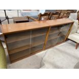 TWO TEAK EFFECT DISPLAY BOOKCASES, EACH WITH TWO SLIDING GLASS DOORS