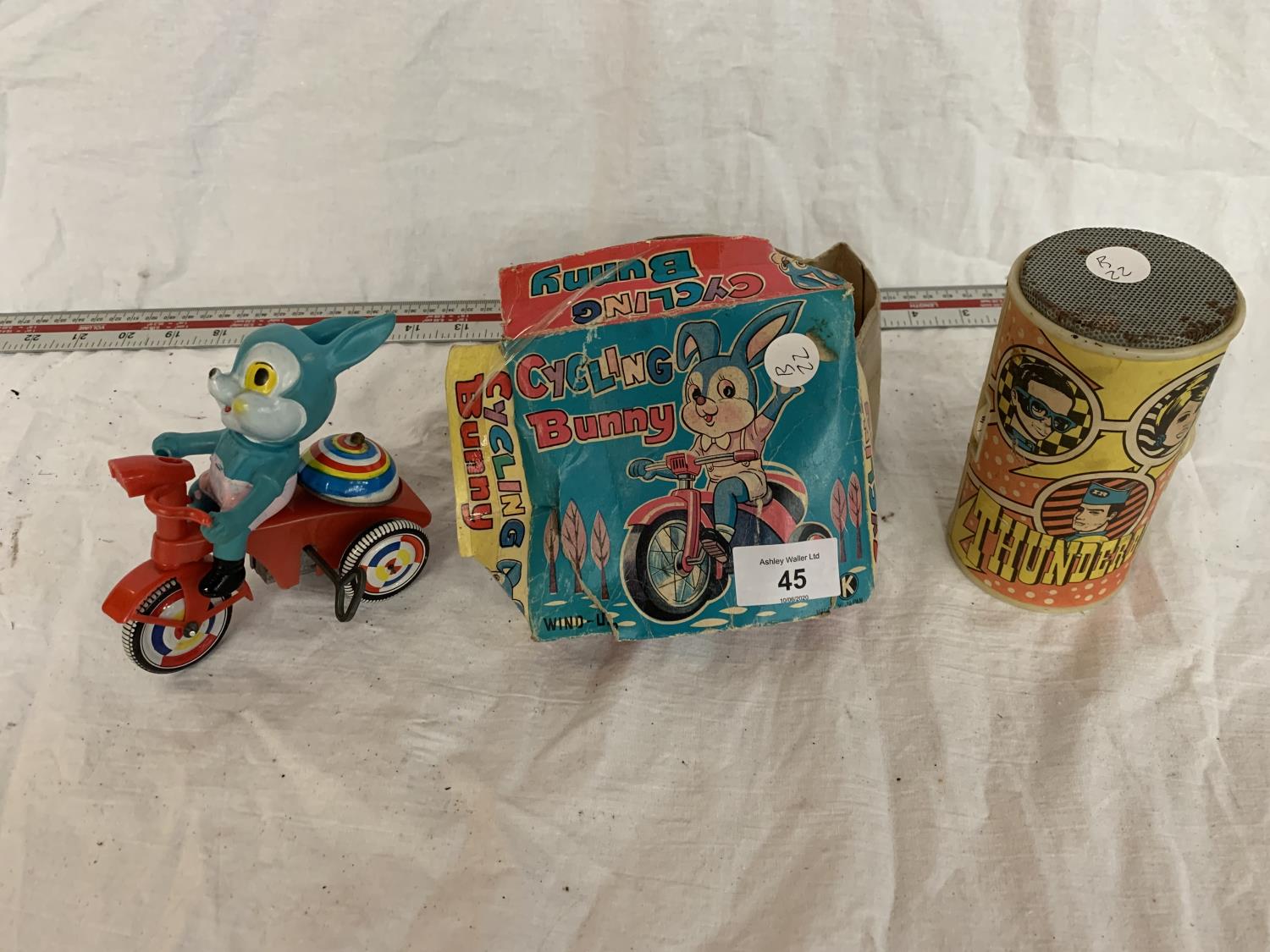 A VINTAGE BOXED RABBIT ON A BIKE AND A THUNDERBIRDS RADIO