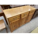 A PINE SIDEBOARD WITH THREE DOORS AND THREE DRAWERS