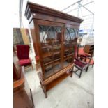 A MAHOGANY BOOKCASE CABINET WITH TWO GLAZED PANEL DOORS AND LOWER SHELF