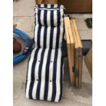 A STRIPEY GARDEN LOUNGER AND TWO WOODEN FOLDING PASTING TABLES