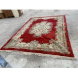 A LARGE RED PATTERNED RUG 365 CM X 275 CM