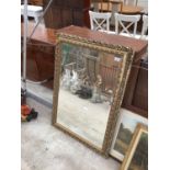 A LARGE GILT FRAMED MIRROR