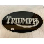 AN OVAL 'TRIUMPH' METAL SIGN 24 INCHES BY 14 INCHES