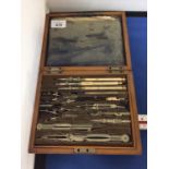 A VINTAGE OAK BOXED TRIGONOMETRY SET