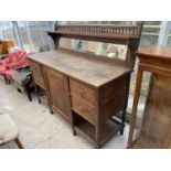 AN OAK SIDEBOARD WITH ONE DOOR, FOUR DRAWERS AND GALLERIED UPPER SHELF (FOR RESTORATION)