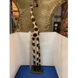 A LARGE WOODEN CARVING OF A GIRAFFE