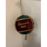 A HARRODS 2001 CHRITMAS BAUBLE IN GREEN AND RED WITH GOLD COLOURED BRAIDING
