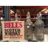 FIVE LARGE EARLY BELLS WHISKEY BOTTLES WITH CORK STOPPERS AND A BELLS BOX