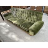 A RETRO GREEN BUTTON BACK FOUR SEATER SOFA