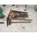 SEVERAL VINTAGE TOOLS TO INCLUDE SAWS, PICK AXE, LUMP HAMMER