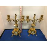 A PAIR OF ORNATE BRASS CANDLEABRAS