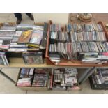 A LARGE QUANTITY OF DVDS, CDS AND VIDEOS