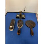 A TORTOISHELL EFFECT THREE PIECE DRESSING TABLE SET COMPRSING OF A MIRROR AND TWO BRUSHES AND A
