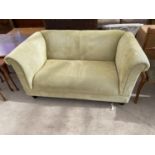 A GREEN TWO SEATER SOFA