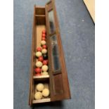 A VINTAGE WOODEN AND GLASS SNOOKER/BILLIARD BALL STORAGE CABINET WITH VARIOUS BALLS