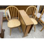 A TEAK EFFECT DROP LEAF DINING TABLE AND TWO PINE DINING CHAIRS