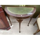 A MAHOGANY DEMI LUNE HALL TABLE WITH GREEN LEATHER TOP