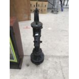 A BLACK CAST IRON WATER PUMP