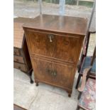 A WALNUT COCKTAIL CABINET WITH FALL FRONT AND SIMULTANEOUS RAISING TOP, TWO LOWER DOORS AND MIRRORED