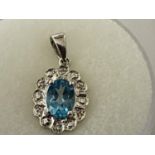 A 9 CARAT WHITE GOLD PENDANT WITH CENTRE OVAL CUT AQUAMARINE AND DIAMOND CHIPS. WEIGHT 1.3 GRAMS.