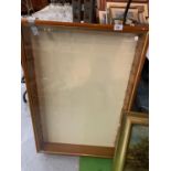 A LARGE DISPLAY CABINET WITH GLASS SHELL