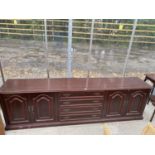 A MAHOGANY SIDEBOARD WITH FOUR DOORS AND FOUR DRAWERS