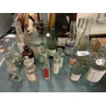 A COLLECTION OF VINTAGE GLASS BOTTLES AND MEDICINE BOTTLES