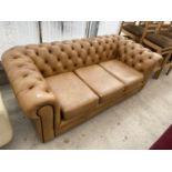 A LIGHT TAN LEATHER THREE SEATER CHESTERFIELD SOFA WITH BUTTON BACK AND ARMS