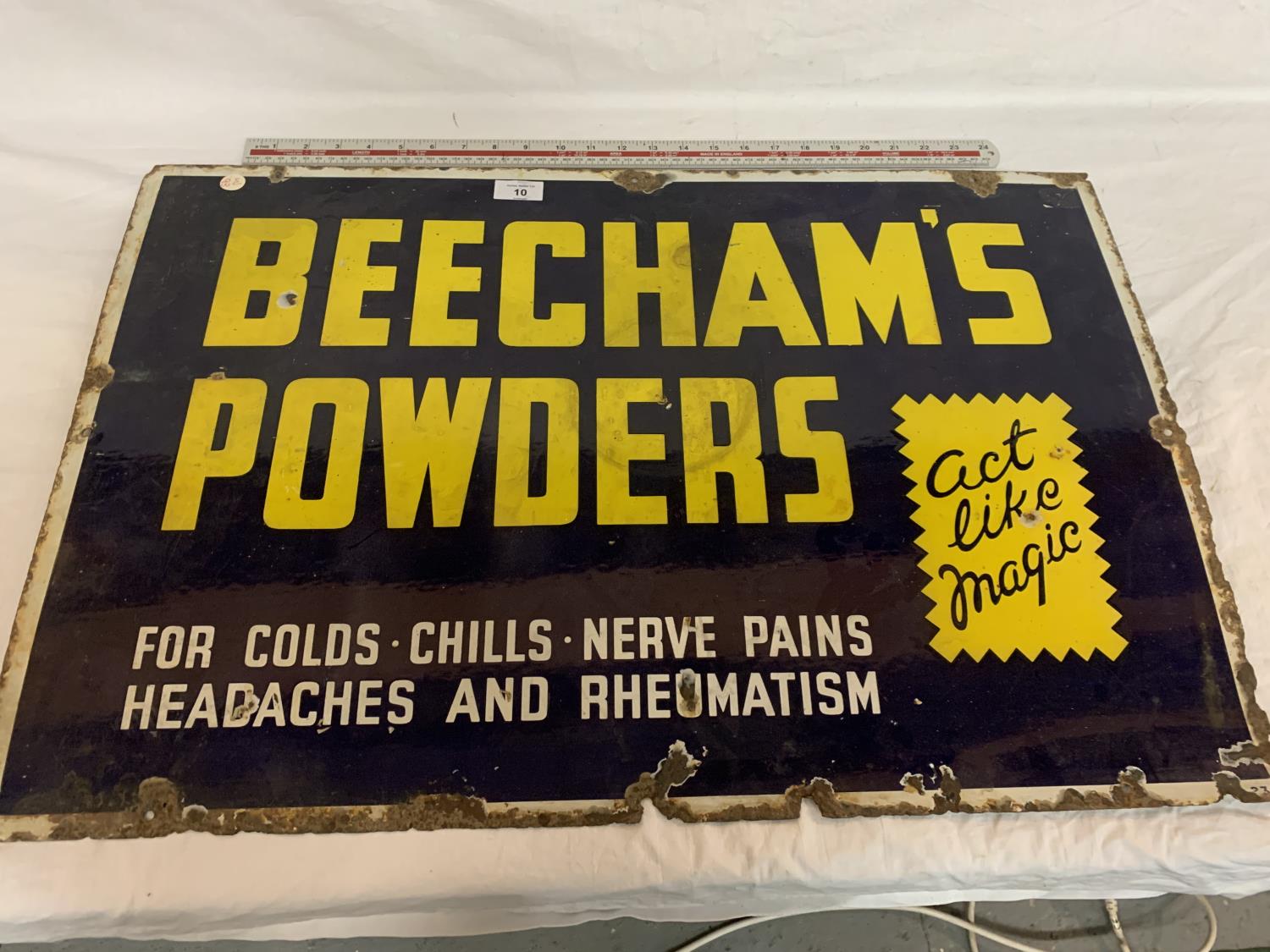 AN ENAMEL 'BEECHAMS POWDERS ACT LIKE MAGIC' ADVERTISING SIGN