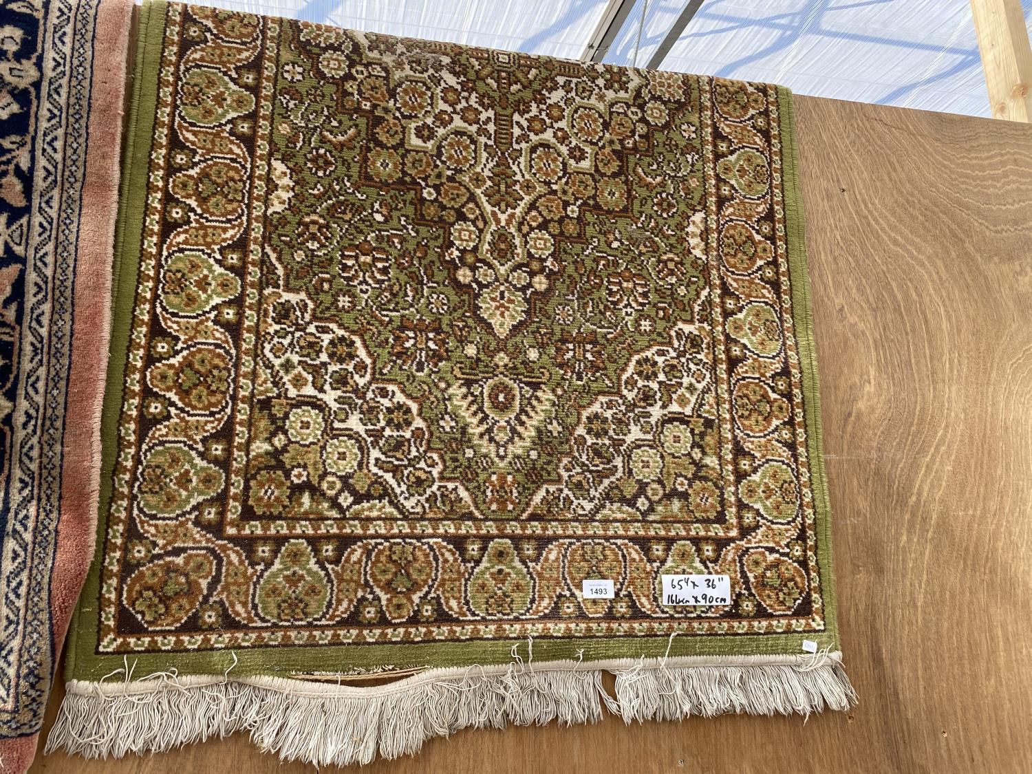 A GREEN PATTERNED RUG