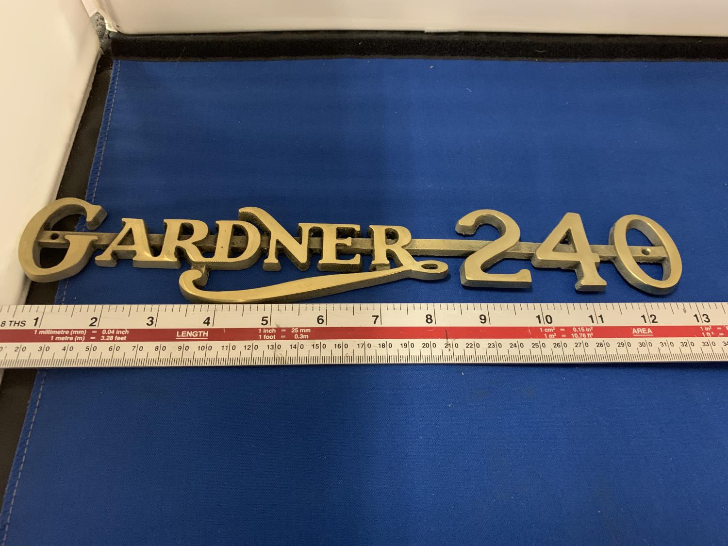 A BRASS GARDNER 240 BADGE