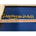 A BRASS GARDNER 240 BADGE