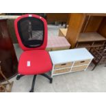 A RED OFFICE CHAIR AND A PAINTED CHEST WITH FOUR BASKET DRAWERS