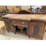 A CARVED MAHOGANY SIDEBOARD WITH TWO DOORS AND TWO DRAWERS