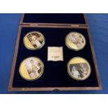 A BOXED SET OF FOUR LARGE COINS DEPICTING JUBILEE CELEBRATIONS