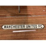 A LARGE WOODRN 'MANCHESTER UNITED FC' SIGN