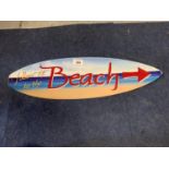 A BEACH SURF BOARD METAL SIGN