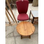 A SMALL PINE COFFEE TABLE AND A RED OFFICE CHAIR