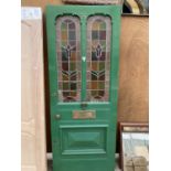 A VICTORIAN FRONT DOOR WITH STAINED GLASS PANELS, BRASS FITTINGS AND KEY