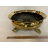 A BRASS OVAL BOWL ON CLAW FEET