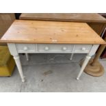 A PINE AND PAINTED TABLE WITH THREE DRAWERS