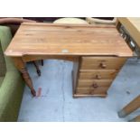 A PINE DESK WITH FOUR DRAWERS