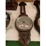 A WOODEN CASED BAROMETER (SLIGHTLY A/F)