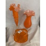 THREE PIECES OF ORANGE GLASSWARE TO INCLUDE TWO VASES AND A BASKET