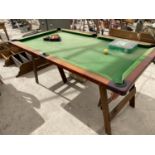 A SNOOKER TABLE WITH SNOOKER AND POOL BALLS