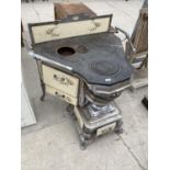 A VINTAGE FRENCH CAST RANGE COOKER WITH ENAMEL PANELS AND DOORS