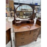 A BOW FRONT MAHOGANY DRESSING TABLE WITH TWO LONG AND TW SHORT DRAWERS, TWO UPPER DRAWERS AND OVAL